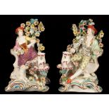 A pair of Chelsea style candlestick figures of Shepherd and Shepherdess, spurious gold anchor marks,