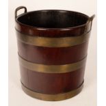 A George III mahogany brass bound peat bucket, with loop handles and three brass bands,