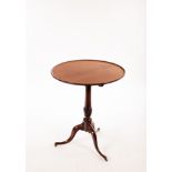 A Regency tripod table, the dished top on a turned column, the outswept legs with barrel castors,