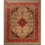 A North West Persian rug, the ivory field centred by a medallion and framed by a raspberry border,