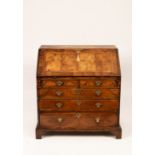 An 18th Century walnut bureau with feather banding, fitted interior and drawer beneath,