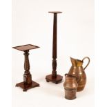 A large coopered oak jug, brass bound, 64cm high, a copper jug and two torchiere's, the largest 133.