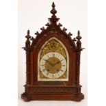 A Victorian oak cased mantel clock of Gothic Revival design, presentation plaque dated 1894,