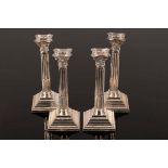 A set of four silver candlesticks, Birmingham 1964, of Corinthian column form, weighted,