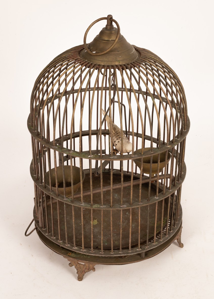 A wirework bird cage of cylindrical form with a dome top,