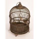 A wirework bird cage of cylindrical form with a dome top,