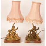 A pair of gilt brass table lights each of a putto on a swan,