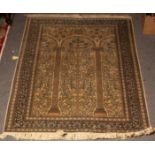 A Nain prayer rug, the ivory field of arched columns framed by an indigo border,