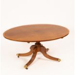 A Regency oval breakfast table on hipped reeded outswept legs,
