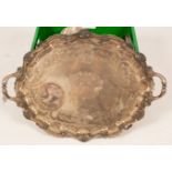 A quantity of silver plate to include a twin-handled tray with scrolling border decorated shells,