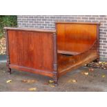 An Empire mahogany lit-en-bateau, with panelled head and footboard,