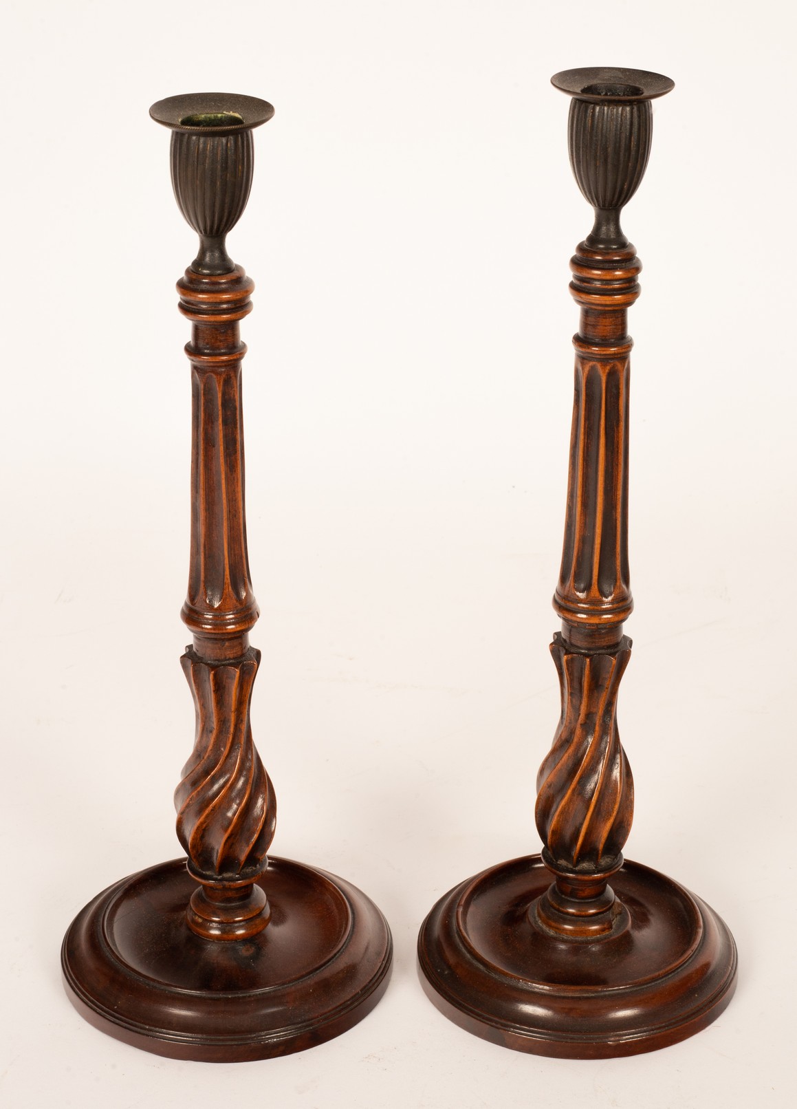 A pair of George III mahogany candlesticks, circa 1770, with brass sconces,