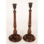 A pair of George III mahogany candlesticks, circa 1770, with brass sconces,