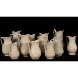Twelve saltware jugs, floral decoration figures,
