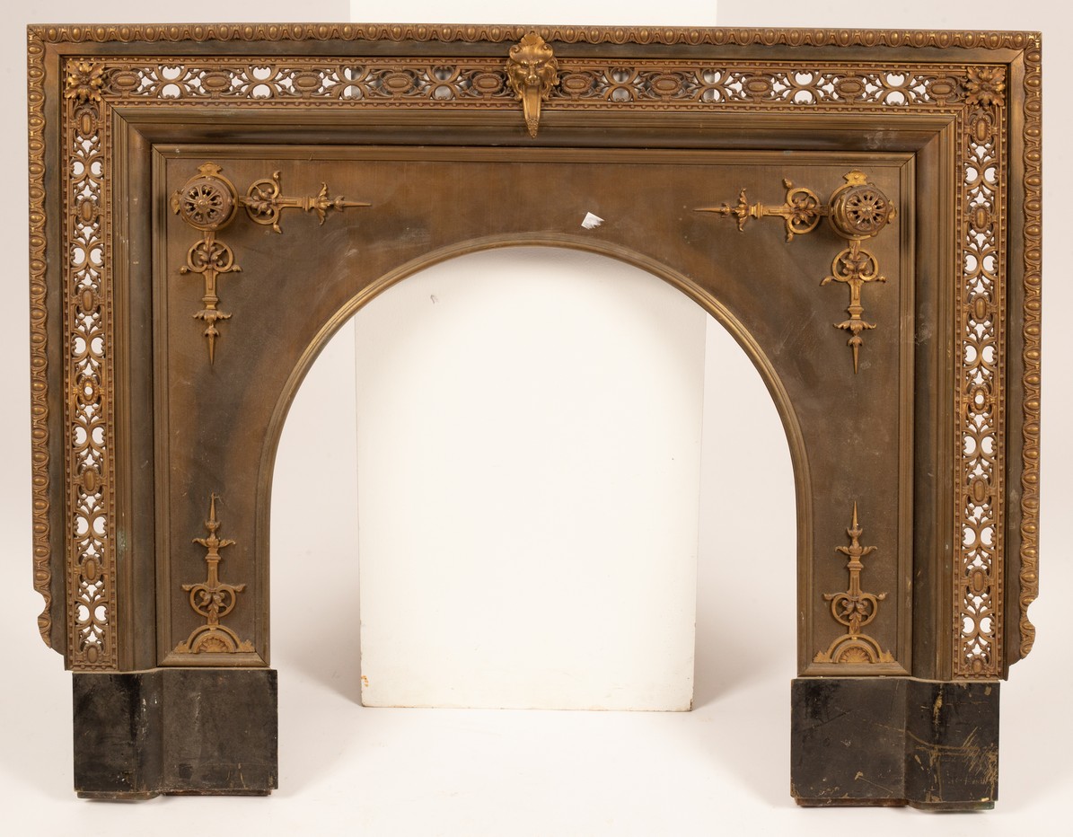 A 20th Century brass fire surround, decorated central lion's head with exposed tongue,