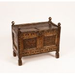 A Scandinavian carved oak chest with panelled cover, 76cm wide, 41cm deep,