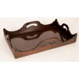 A George III mahogany tray, circa 1780, of rectangular form with wavy gallery and cut out handles,