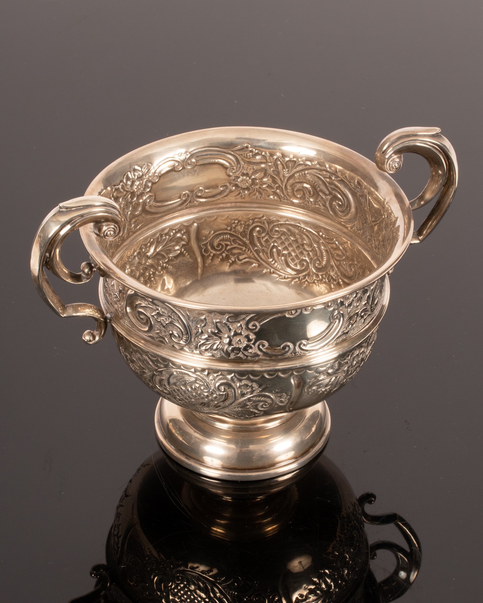 An Edwardian silver two-handled cup, Birmingham 1909, with embossed decoration, 16.