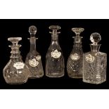 Five cut glass decanters and enamelled decanter labels/Provenance: The Estate of the late Diana &