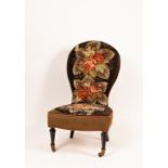 A Victorian nursing chair with beadwork back and seat on ebonised legs,