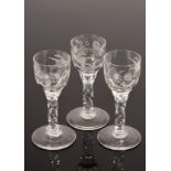 Three 18th Century style wine glasses with facet stems and engraved bowls,