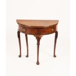 A George II walnut half round table, with folding top on cabriole legs,