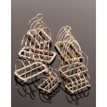 Three pairs of silver toast racks, Victorian and later, various makers,