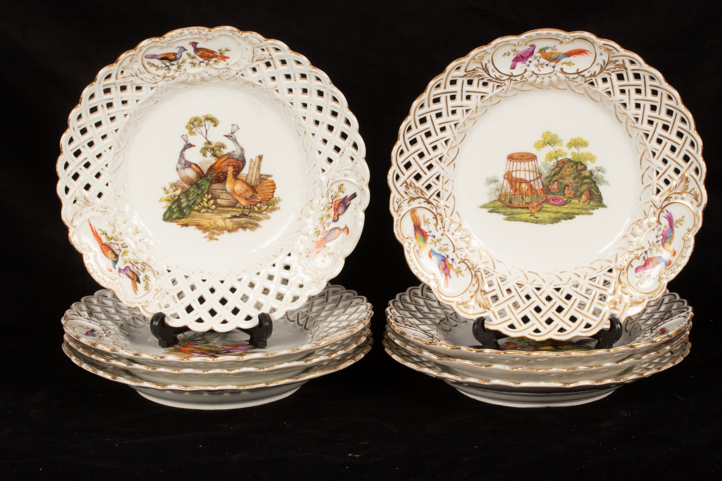 Eight Meissen ornithological pierced plates, late 19th Century, the lattice rims heightened in gilt,