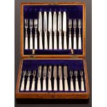 A cased set of twelve silver dessert knives and forks, with pearl handles, TL, Sheffield 1913,