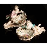 A pair of Sitzendorf porcelain sweetmeat baskets with recumbent gallant and companion,