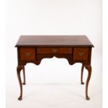 An 18th Century walnut dressing table, on cabriole legs with pad feet,