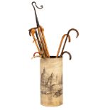 An oval umbrella stand decorated a Venetian scene, 53cm high, containing walking sticks,
