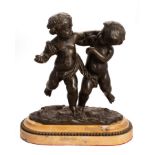 An Italian 19th/early 20th Century bronze statue of two putti upon a marble plinth with beaded