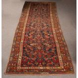 A North West Persian runner, circa 1900, the abrashed indigo field with an all over Herati design,