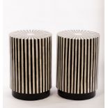 A pair of inlaid, black and white painted wood drum tables or plinths,