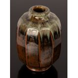 Mike Dodd (born 1943), a cut sided stoneware footed vase, the lipped rim with running ash glaze,