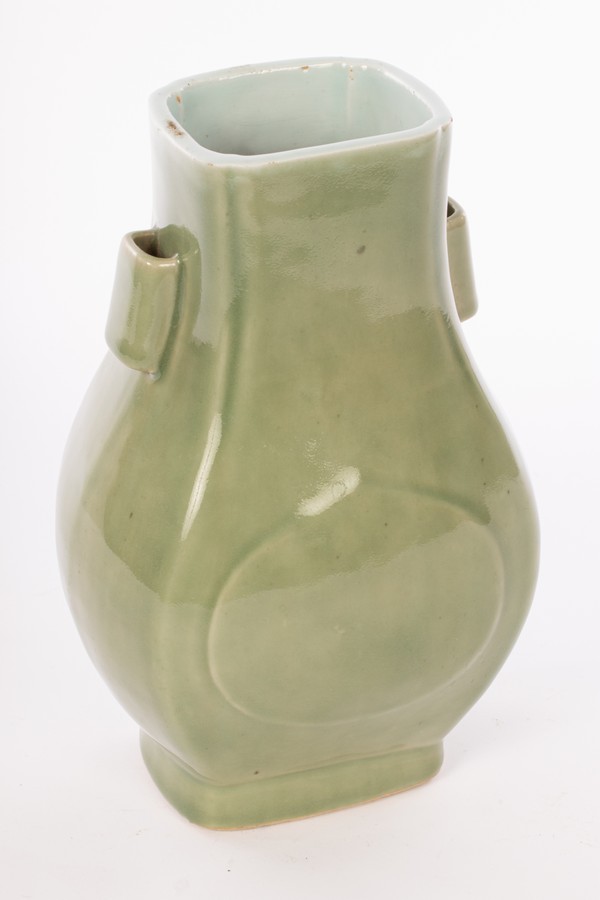 A Chinese monochrome celadon porcelain vase with two handles, Guaner Fanghu, Qing Dynasty,