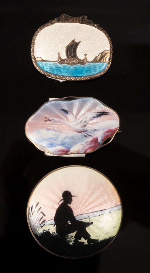 Three Norwegian guilloché enamel brooches, one by Aksel Holmsen depicting a bird in flight,