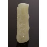 A Chinese celadon jade carved piece in the form of a section of bamboo and plum flowers,