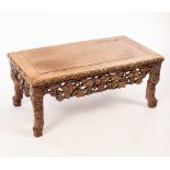 A Chinese table, 19th/20th Century, possibly Huanghuali Kang, carved with fruiting vines,