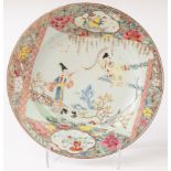 A Chinese famille rose plate, Yongzheng (1723 - 1735), decorated with figures in the garden,