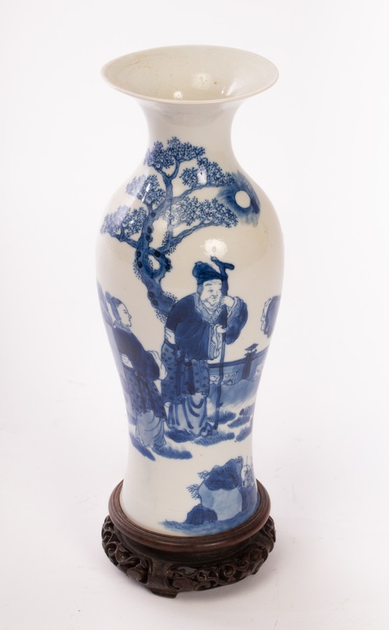 A Chinese blue and white baluster vase, Qing dynasty, decorated figures on a terrace,