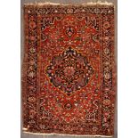 A Bakhtiar rug, South Persia, the madder field with scrolling vines,