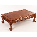 A Chinese mahogany coffee table, 20th Century, with finely pierced carving of dragons,