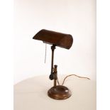 A copper finished metal desk lamp, with articulated shade,