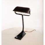 A painted metal desk lamp with articulated plastic arm and shade,