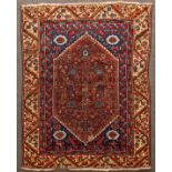 A Demirje Kula rug, West Anatolia, the deep rust red fields with vases issuing vines and palmettes,