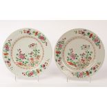 A pair of Chinese famille rose porcelain plates, Qianlong, decorated with chrysanthemums, peonies,