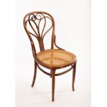 A Thonet bentwood chair with stylised heat design to the back and cane seat CONDITION