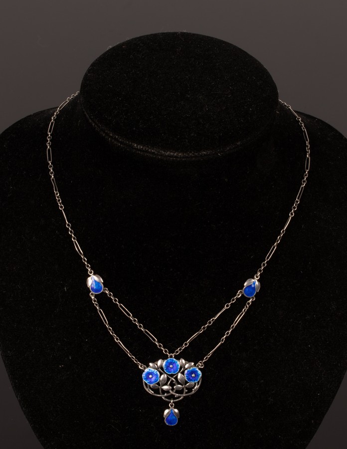 An Art Nouveau silver and enamel pendant necklace in the style of Liberty,